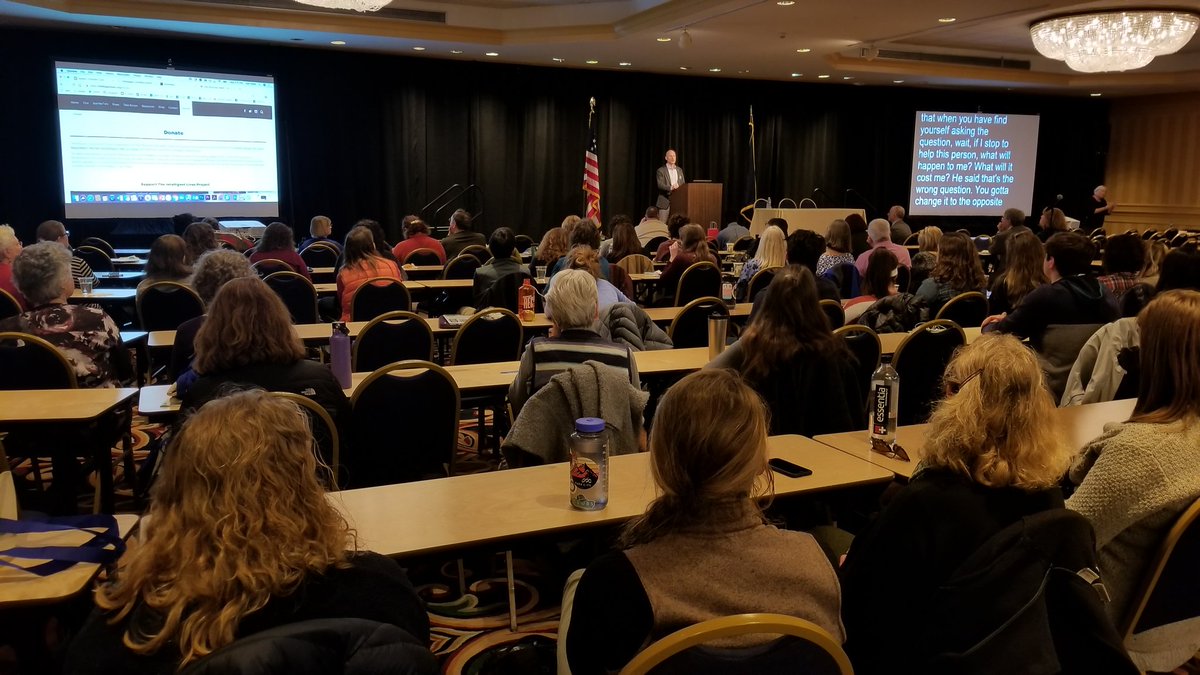 Man addresses crowd from podium