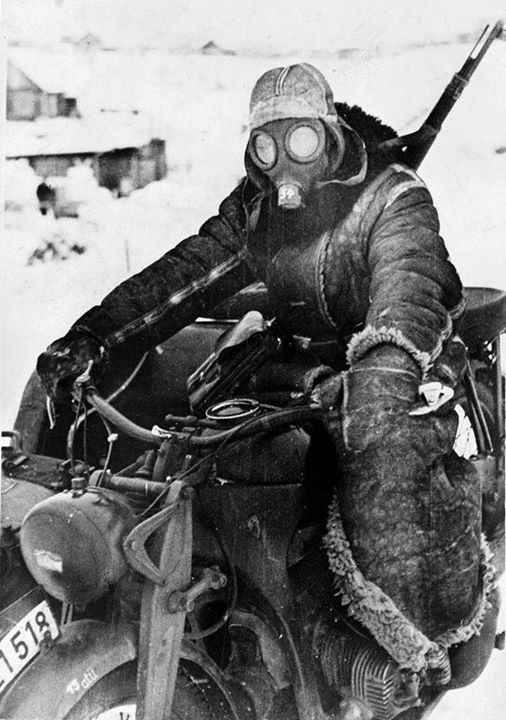 WW2Vehicles's tweet image. A German soldier rides a motorcycle in the snow on the Eastern Front, wearing a gas mask to protect from the extreme cold. February 18, 1942