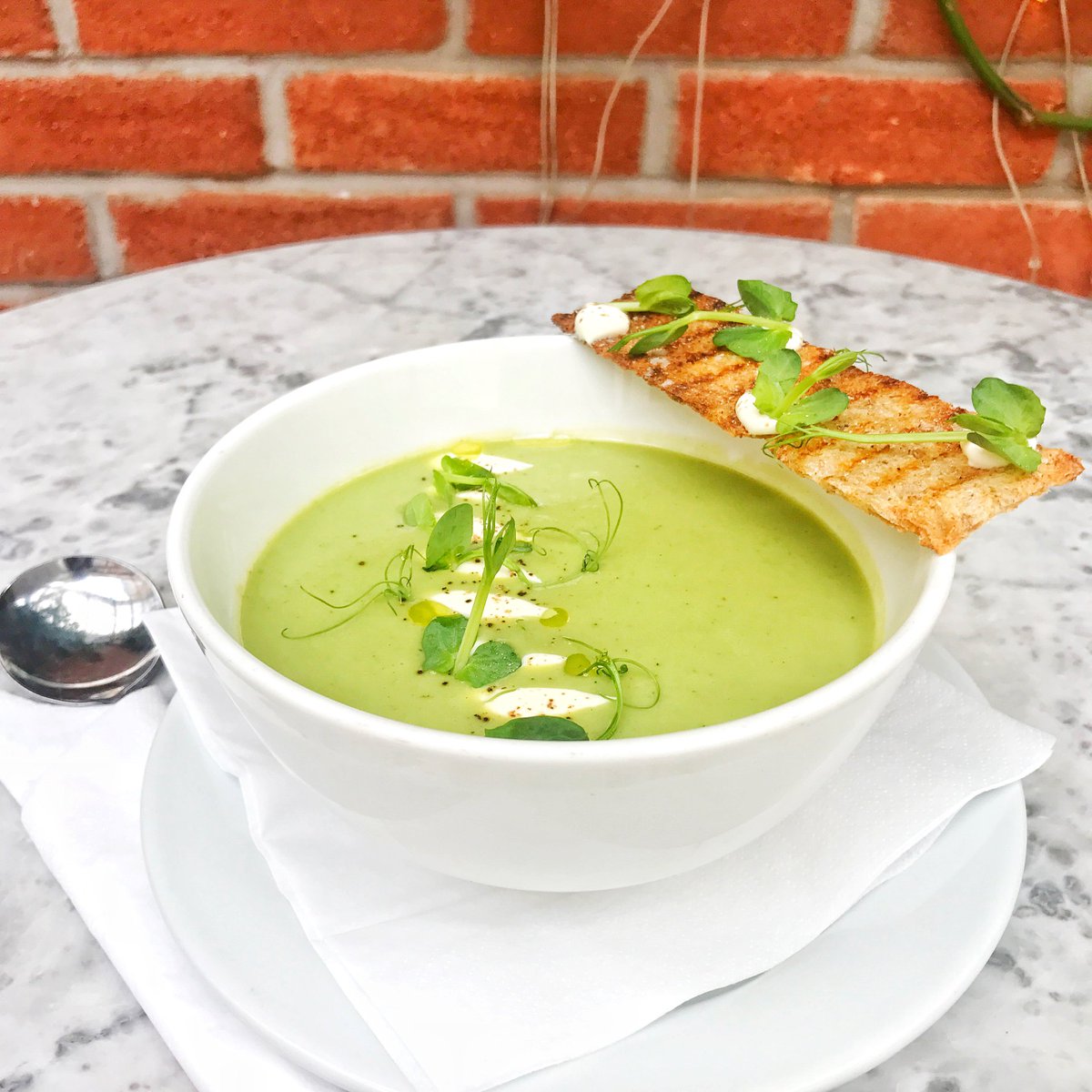 Springtime calls for our English Pea & Mint Soup, a silky summer soup served hot or chilled, made with fresh local English peas, mint Chantilly cream and sourdough toast on the side. #DABLondon #DominiqueAnselLondon