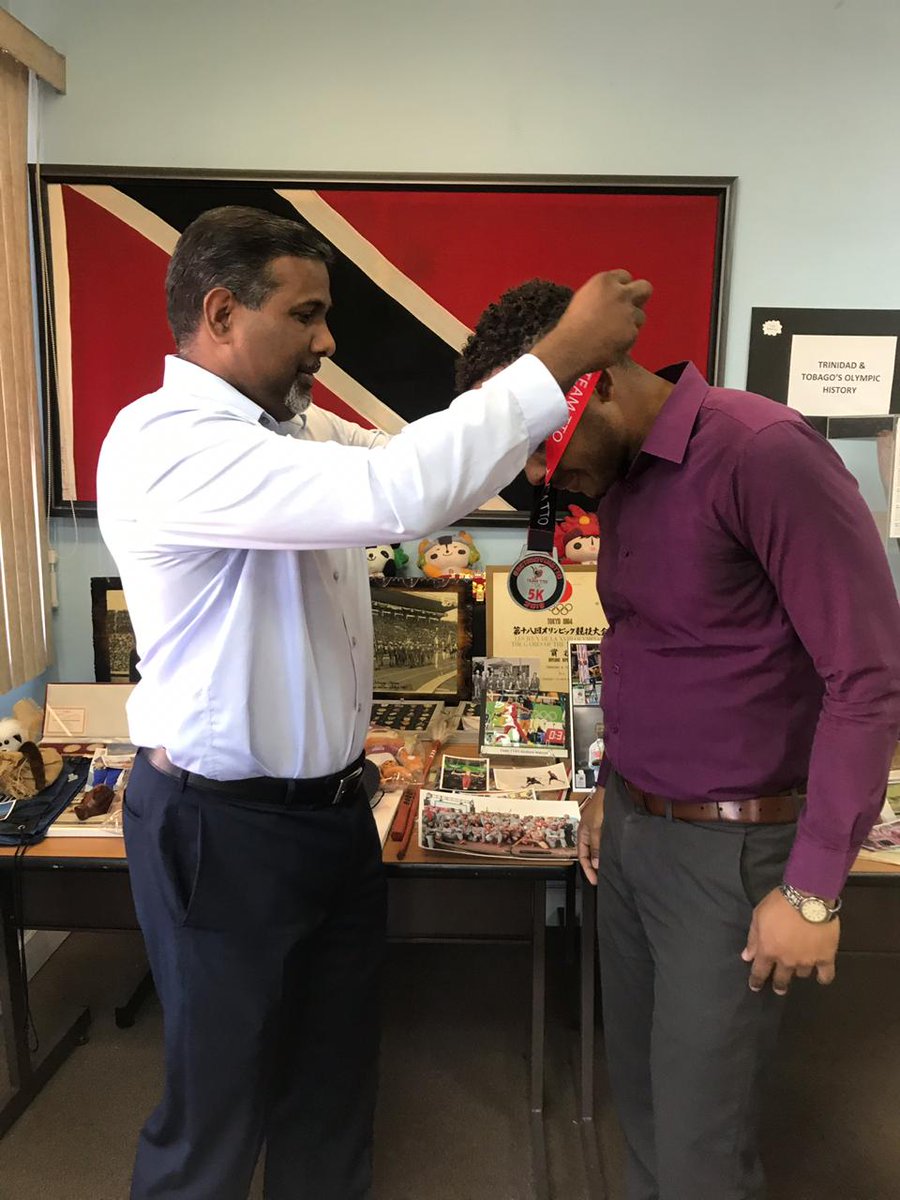 TTOlympic's tweet photo. Former West Indies cricketer Dinanath Ramnarine presented
Timothee Maloney from the Ministry of Sport with his #GetMovingTTO Virtual 5k medal yesterday @ Olympic House😎
Congratulations 🎉 🎊
#teamtto #weonamission #Stayactive @kingdom_mgmt_868 https://t.co/4oq7UYtFRq