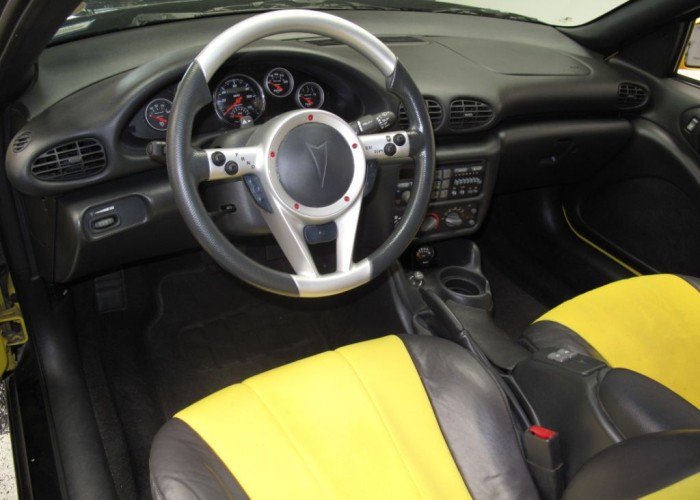 gmbeatonline's tweet photo. Inside the #Pontiac Sunfire Piranha you won’t find a typical shift level in the center console. Instead the 4-speed automatic Tiptronic shift system had buttons on the steering wheel. Note the P-R-N-D buttons. (Photo credit @HemmingsNews) #FlashbackFriday #GMBfeatures https://t.co/QrNnhur4Oi