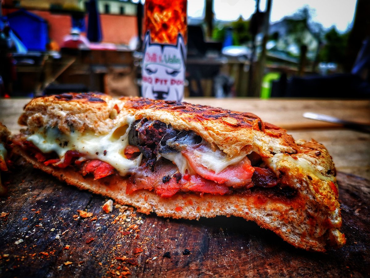 devonwoodsmoke's tweet photo. How about this for a breakfast of Kings, a nice loaf, good bbq sauce, crispy bacon, black pudding, mozzarella, wrapped in foil and cooked on the bbq until bread is toasted and mozz melted... Enjoyed with @CliftonChilli boys, #ukbbq #bbq https://t.co/umezqCbGII
