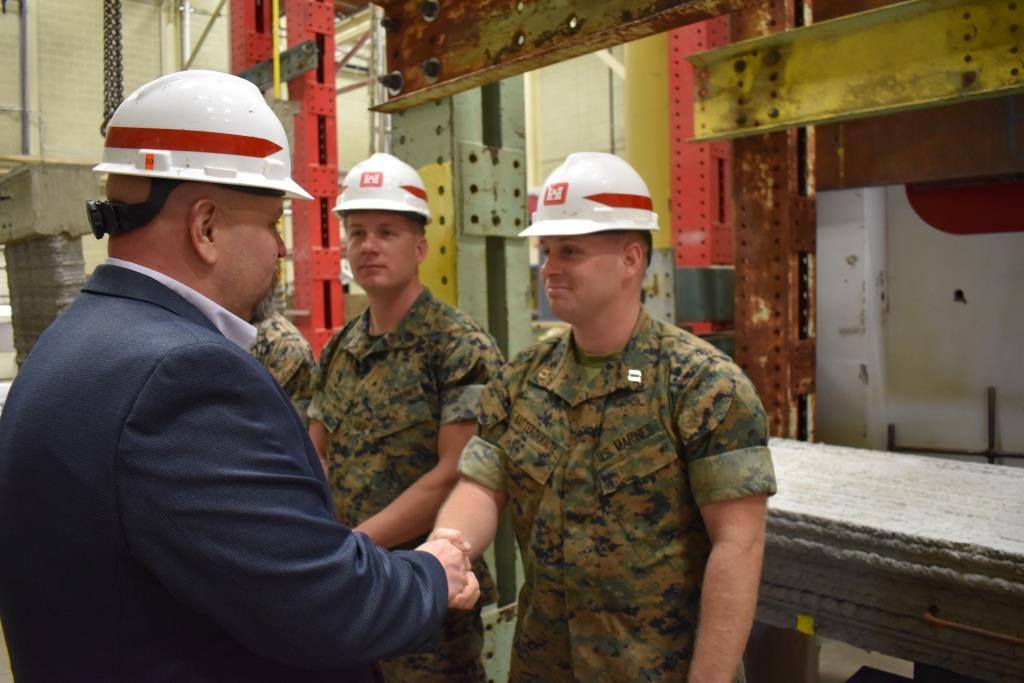 USACEHQ's tweet photo. Tim  Shelton, Interim Facilities Division Chief of the @ArmyERDC #CELab presents a military coin to Capt. Eric Satterthwaite of the 7Th Engineer Support Battalion, @MCIWPendletonCA Capt. Satterthwaite supported several technology demonstrations of the #ACES3D. https://t.co/kvoJDjvaxp