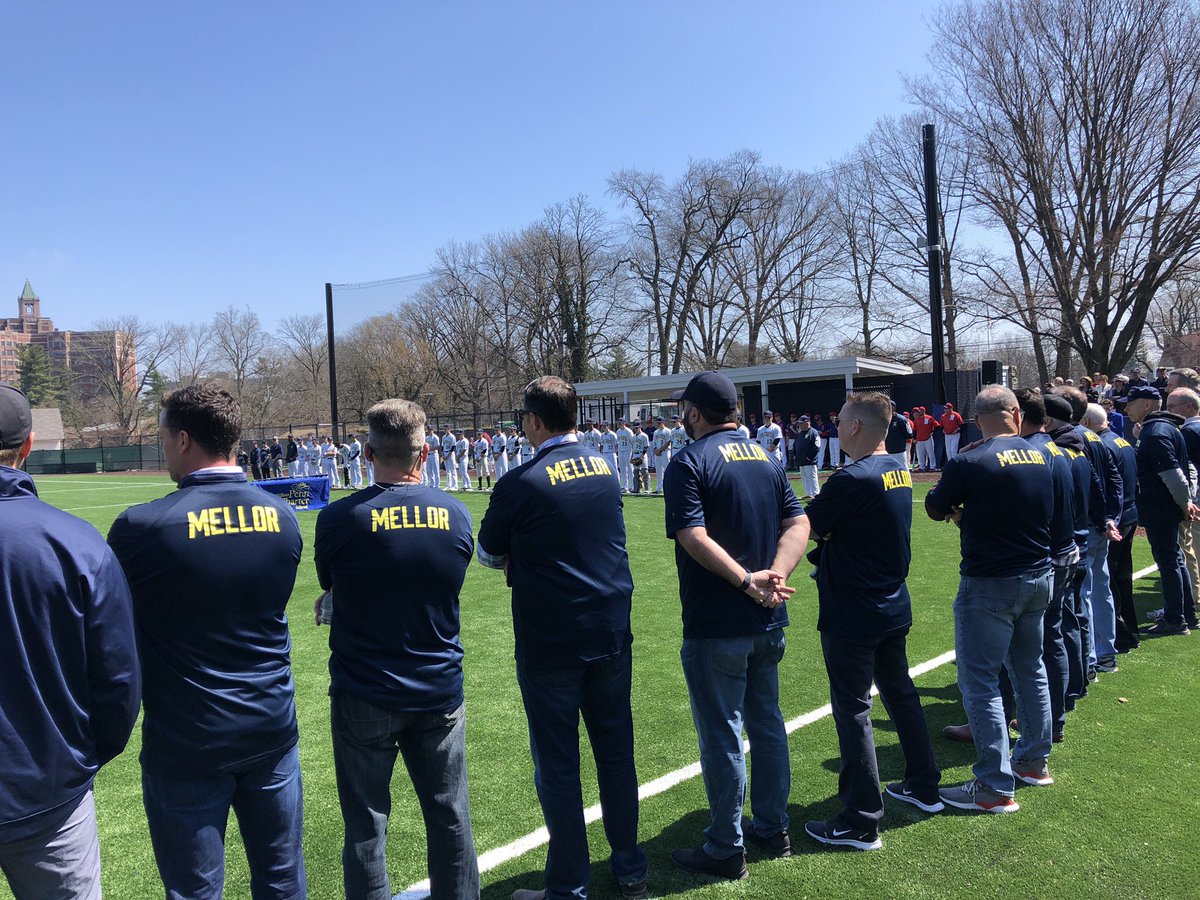 PennCharter's tweet photo. Former players line up on third base line wearing shirts bearing their coach’s name. #PalaiaField #HowFarPC https://t.co/ZUIVsUmThq