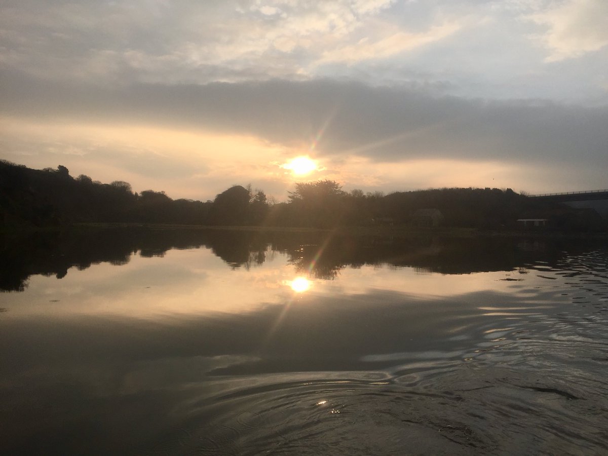 Early morning on the Camel with only the ripples from the boat disturbing the mirror like reflection.