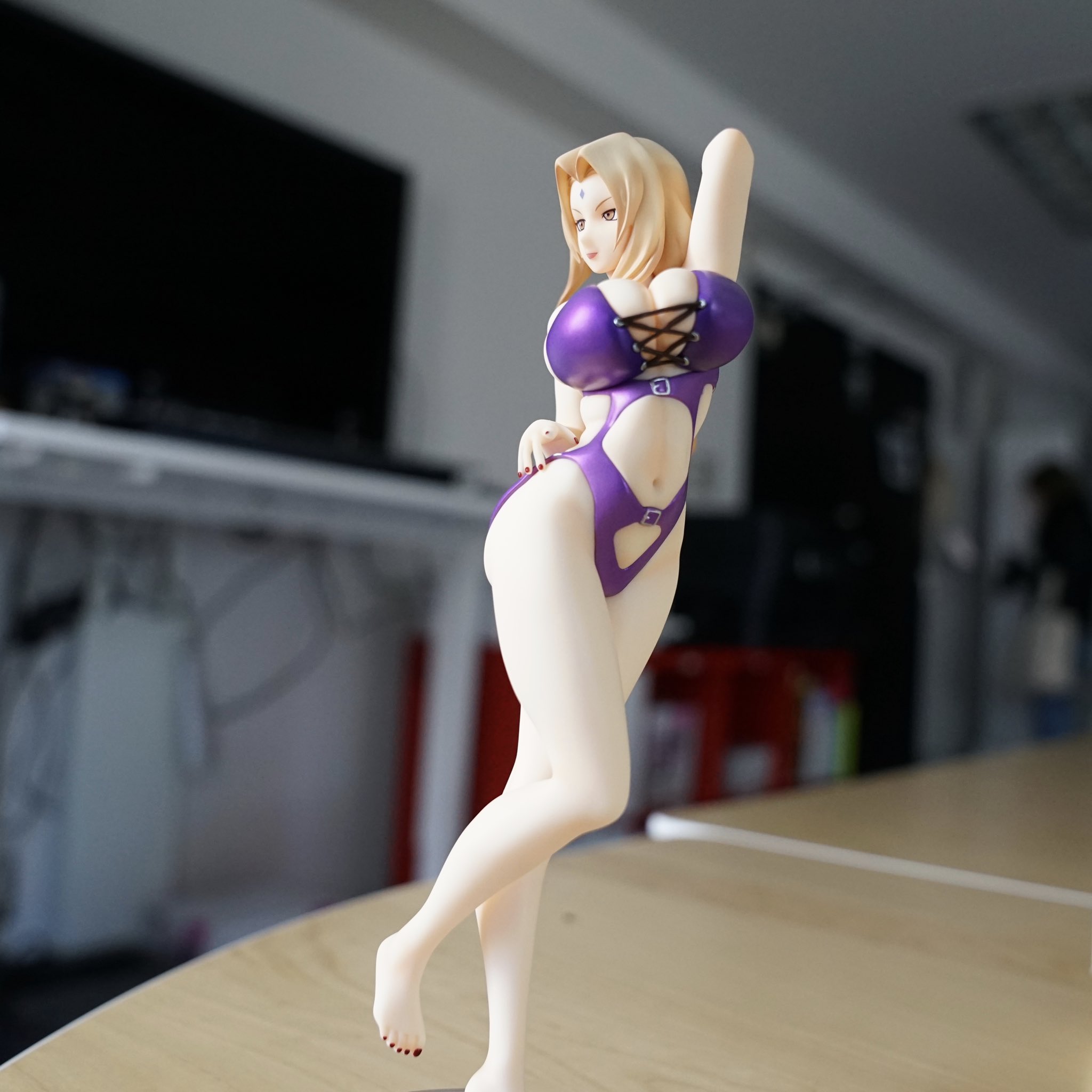 The figure captures Tsunade's impressive body wearing the purple swims...
