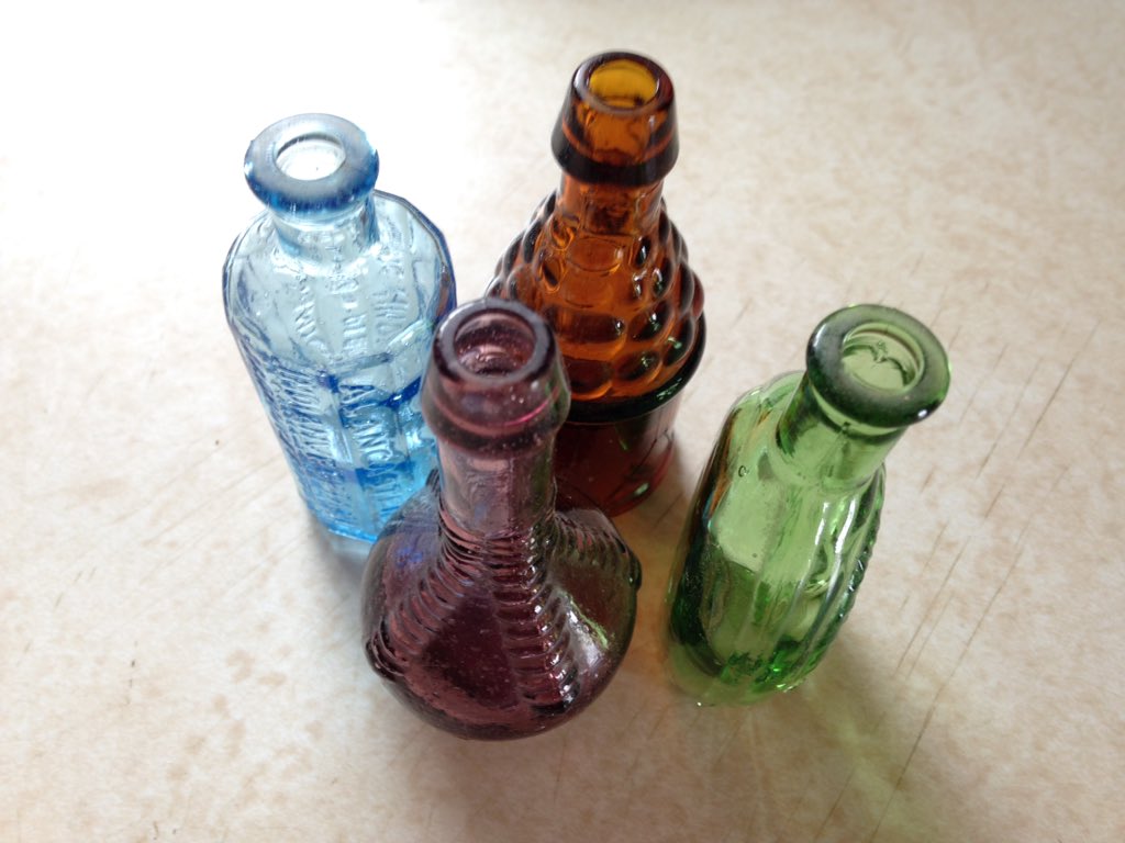 ephemerily's tweet image. This week on #getridofonething ... glass bottle collection! My gramma had blown glass vases on her windowsills. My sills are too narrow but I saw these tiny bottles and thought, those will fit. It was never the same. #clearclutter