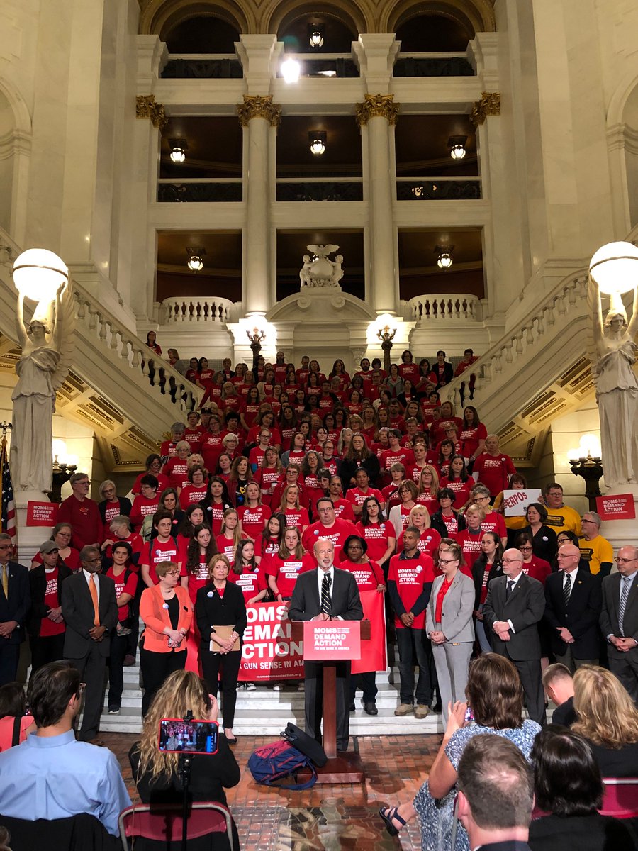 Governor Wolf standing in front of large group on Capitol rotunda steps wearing read Moms Demand Action shirts