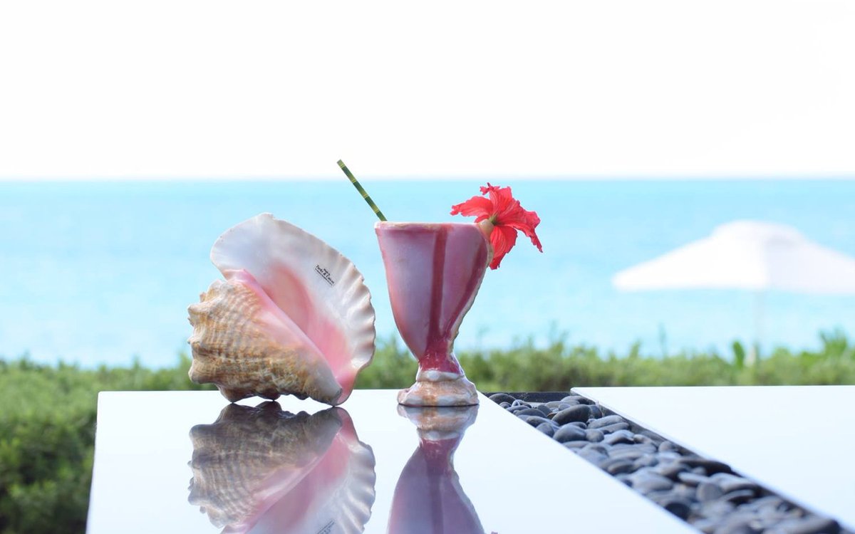 Waiting for Rock House to break ground this month? Be sure to try your favorite cocktail in a new conch shell serving glass at our sister property <a href="/GraceBayClub/">Grace Bay Club</a>. To learn more, click here: bit.ly/2oK2cQO #rockhouse #rockhouseresort #rockhousehotel #providenciales