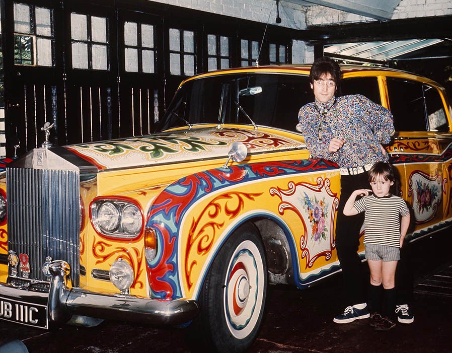 On this day in 1967, <a href="/johnlennon/">John Lennon</a> brought his Rolls Royce Phantom V to be customized and psychedelic-ized. Standing next to his daddy is <a href="/JulianLennon/">Julian Lennon</a> and today is also Julian's birthday.