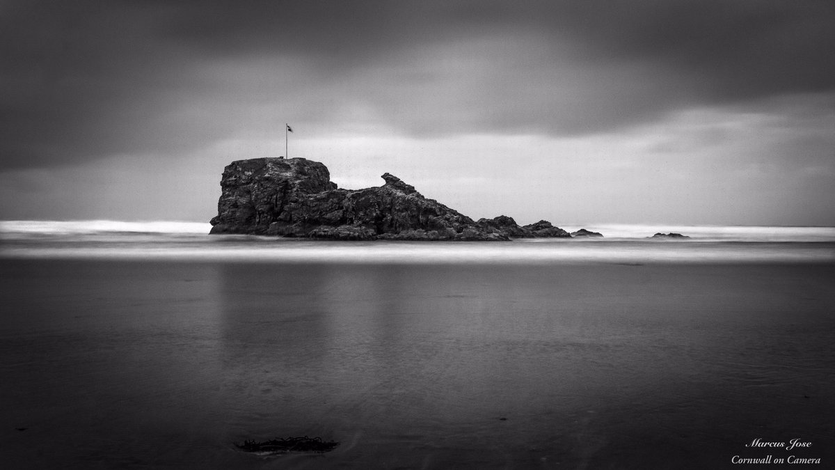 Cornwalloncam's tweet photo. A long exposure black and white view of Chapel Rock on Perranporth Beach, was hoping for a nice sunset view but the clouds soon ruined that so I had to get creative!! 
#cornwall #perranporth #beach #blackandwhitephoto #photography #art #tide #longexposure #moodygrams https://t.co/6EDhCw5wTi