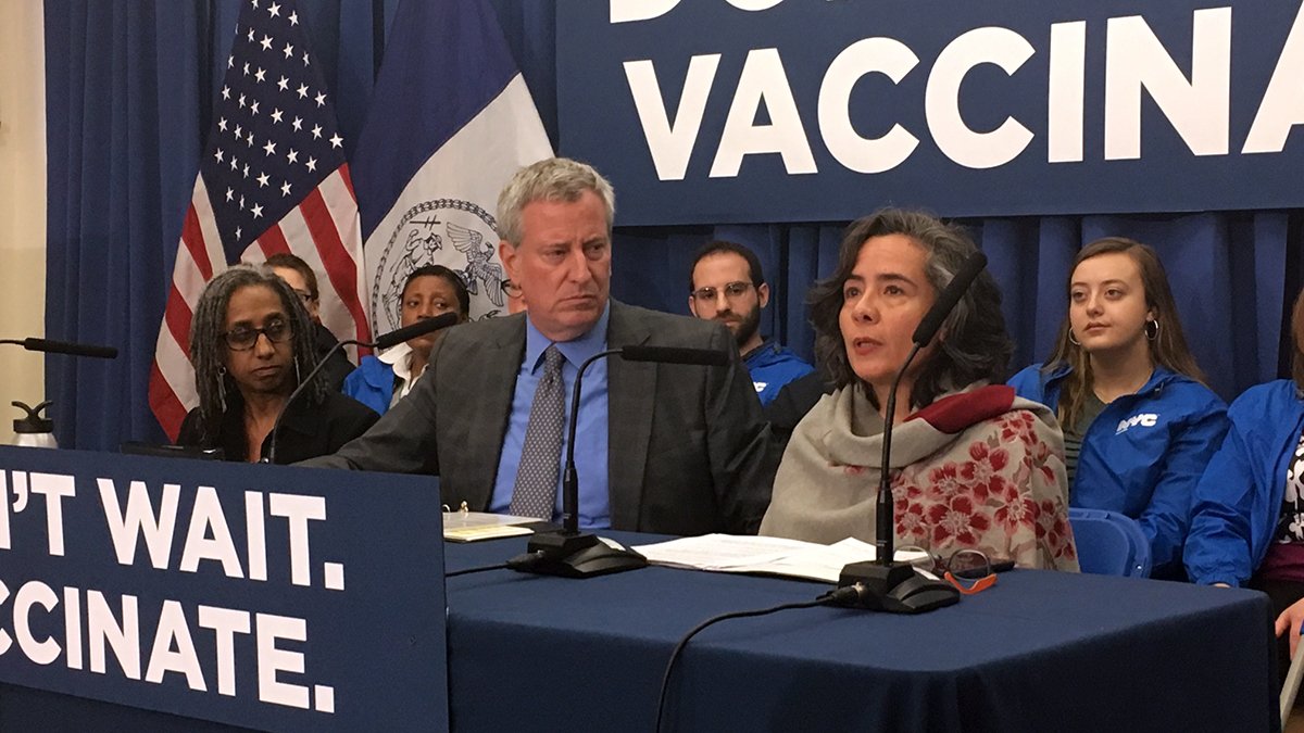 Dr. Barbot speaks at a press conference. Mayor de Blasio and Deputy Mayor Palacio sit to her left.