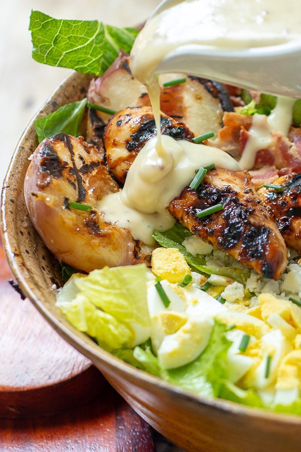 Grilled Chicken Salad has an easy, homemade honey mustard serves as both the chicken marinade and dressing. Toss with whatever is on hand, such as greens, avocado, corn, bacon, blue cheese, or hard boiled eggs, and you have a healthy, filling meal! mamagourmand.com/grilled-chicke…