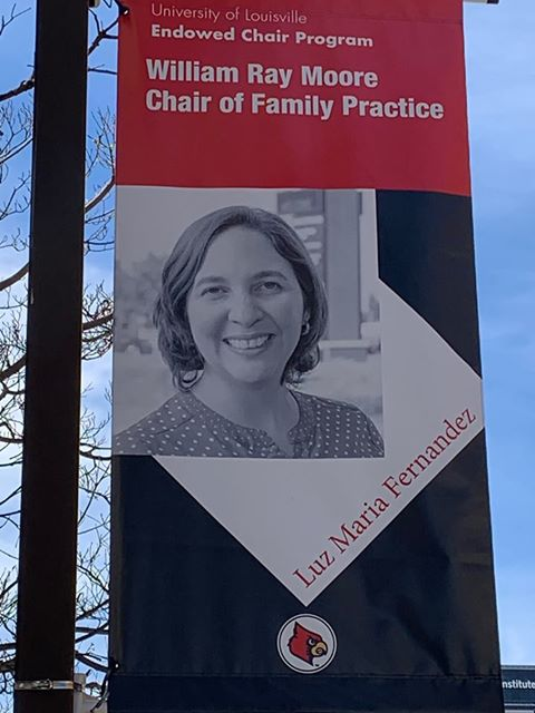 UofLEcon's tweet photo. So apparently there is a banner up of my wife in downtown Louisville because she received an endowed chair. I encourage everyone to take a picture with it and hashtag it #DrLuzSelfie . @uofl @DrLuzFamMed @uoflhsc https://t.co/eHQeaEKmz9
