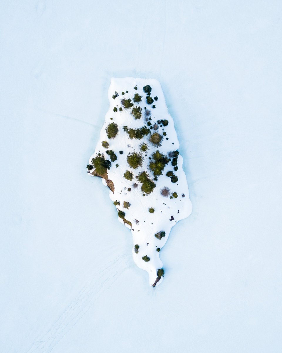 Patches of vegetation poke through a snow-covered island on Gold Creek Pond, located in Kittitas County, Washington. See more here: bit.ly/2WYZvIs /// #dailyoverview #aerialphotography #earth #nature #picoftheday #goldcreekpond #washingtonstate #cascaderange #adventure