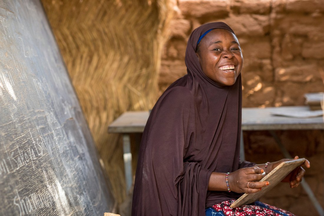 “I’m happier because I can read and write,” said Kandé Moussa from Ounwala Haoussa community. “I’m proud of myself. This is for self-development.” Photo credit: Michael Stulman, CRS