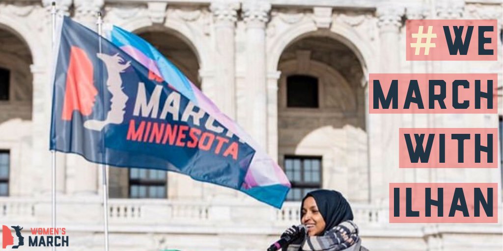 Rep. Ilhan Omar standing next to a Women's March Minnesota flag