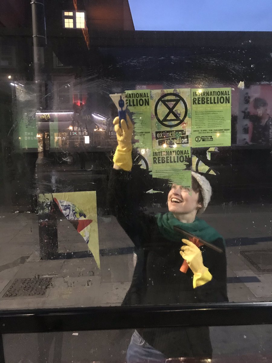 XRTowerHamlets's tweet photo. Yes, we #rebel, we cause #disruption. We act with good conscience, & we hold ourselves #Accountable. And #WeCleanUp. Here, #XRSeahorses & a passer-by aspiring rebel taking down #RebellionWeek flyposting so bus users can see through again. #Sorry for the disruption. @ExtinctionR https://t.co/GX8FFsyRZn