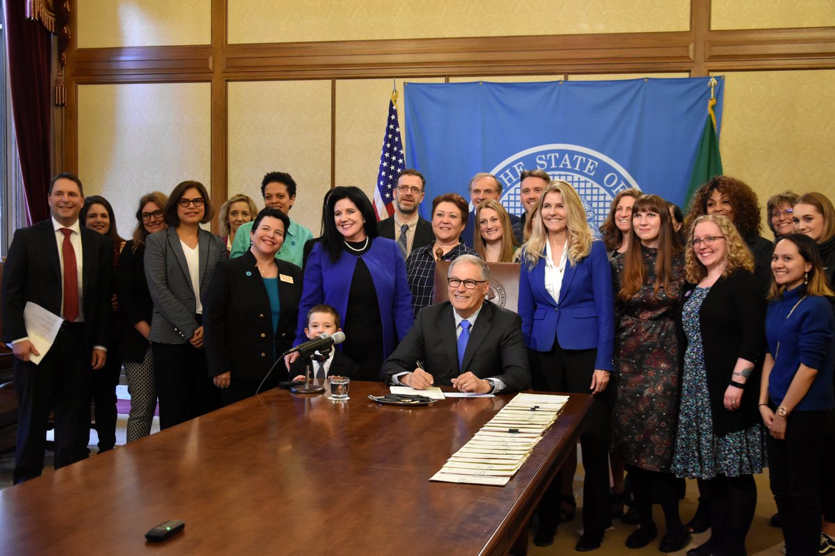 Signing House Bill 1166, which sets storage requirements for unreported sexual assault kits and prohibits destruction of untested rape kits — no matter how old — through a temporary moratorium, with Rep. Tina Orwall and supporters of the bill. 