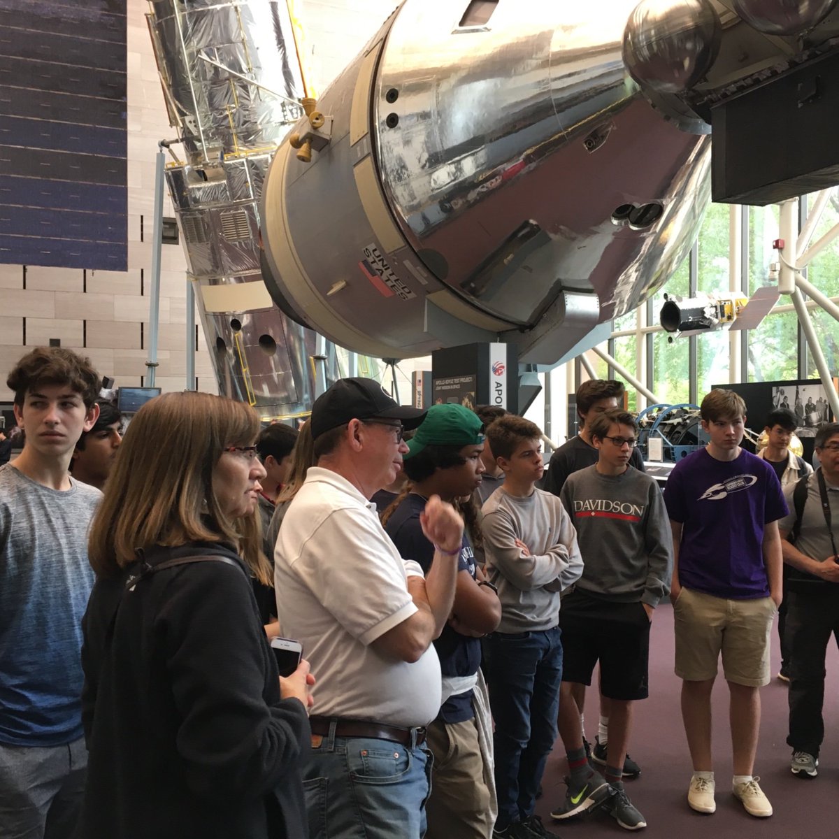 RobinGallaher1's tweet photo. Carrboro High students at the National Air and Space Museum in Washington D.C. with the Hubble and Apollo in the background. https://t.co/hCFPrmoIS1