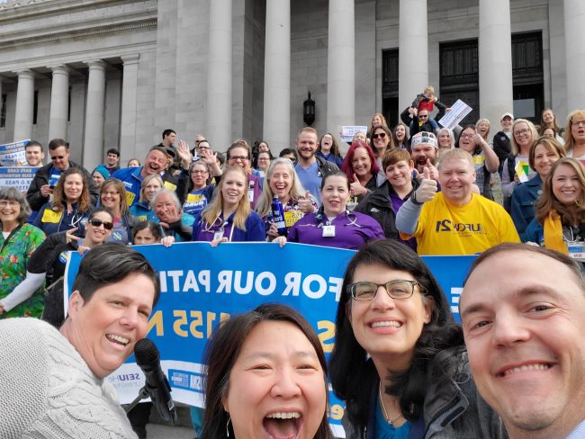 Sponsor of the meal and rest break legislation, Representative Marcus Riccelli, with Representatives My-Linh Thai and Nicole Macri, standing in front of a crowd of nurses and health care workers