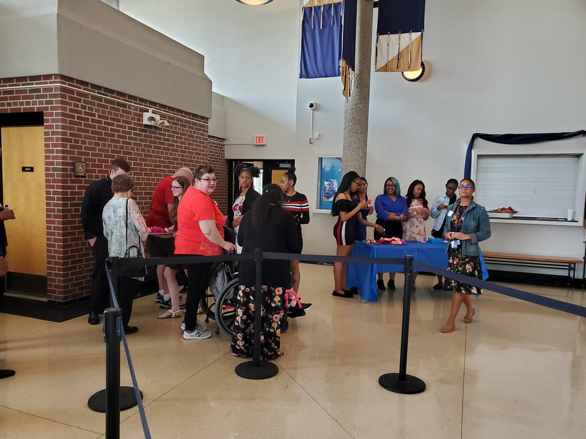 Jen_Crotty's tweet photo. Seniors beginning to arrive and meet their FHS Senior date for the evening! Corsage....then a formal picture...and then a gathering in the auditorium to wait for the play to start. In the cafeteria, Mr. Holm takes a minute from prepping to smile for the camera! #FitzNation https://t.co/mwSe1MigLH