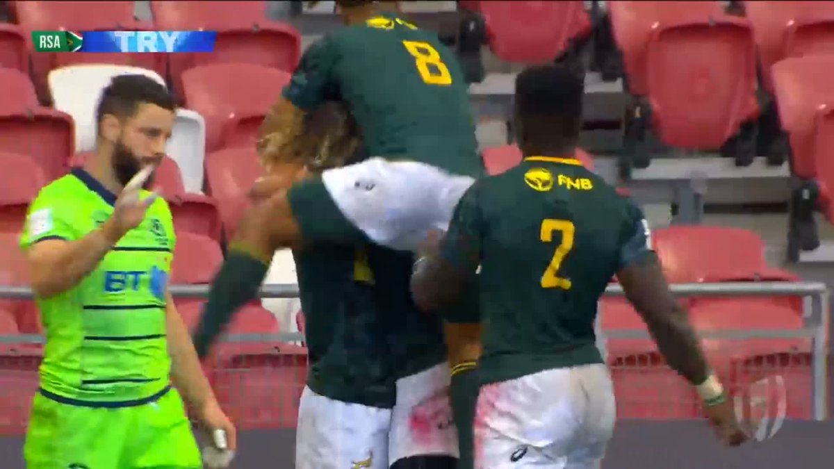 Whole team runs in to celebrate with Angelo Davids as he touches down