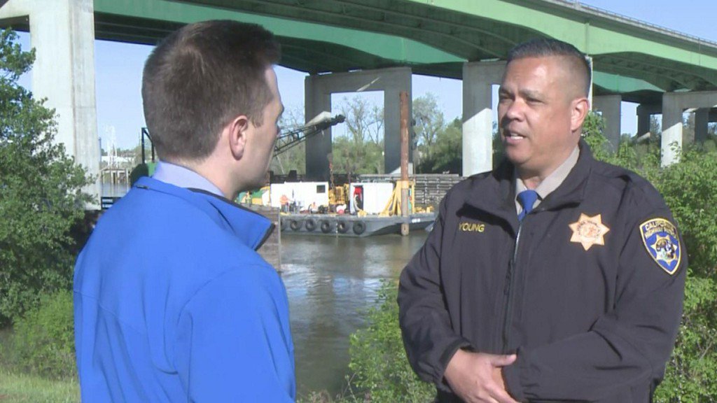 Officer Jim Young explains tow truck recovery from Sacramento River