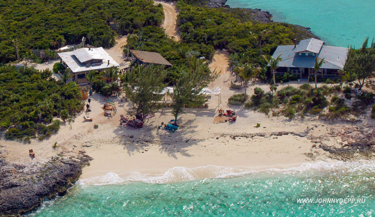 Again. Bahamas 2014 and her claim that "Johnny kicked the door so hard that it splintered". Photos attached as Exhibit 4. Open Exhibit 4 and see the massive door and part of a blue beton wall. Where on his island where all the houses are wooden she found that door and that wall?