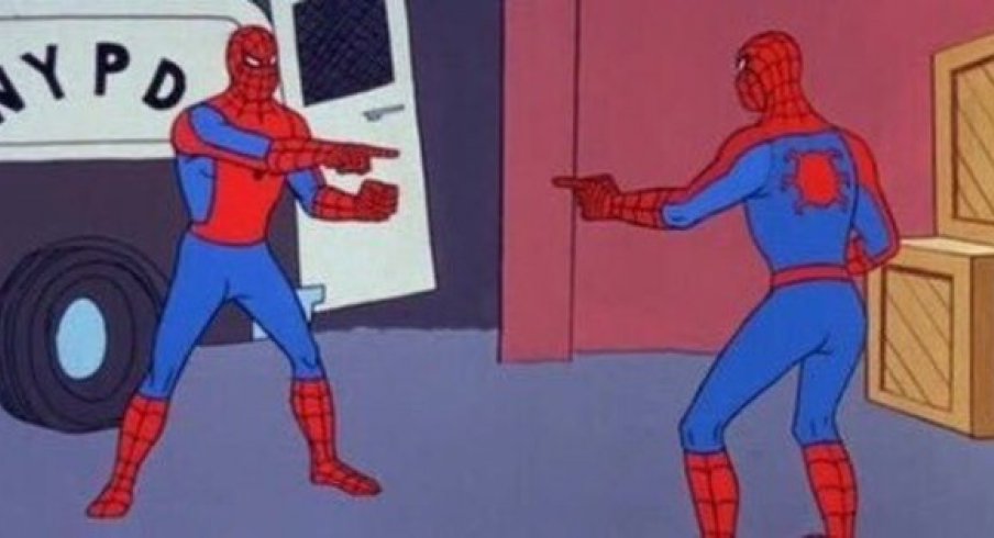 Two spiderman pointing at each other.