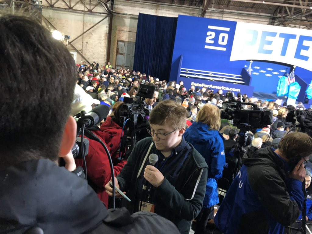 ktmcnulty's tweet photo. @PennNewsNetwork reporters, Kenny &amp; Jack recording stand-ups before @PeteButtigieg takes the stage in a soggy @DTSouthBend https://t.co/51sfdeiBZr