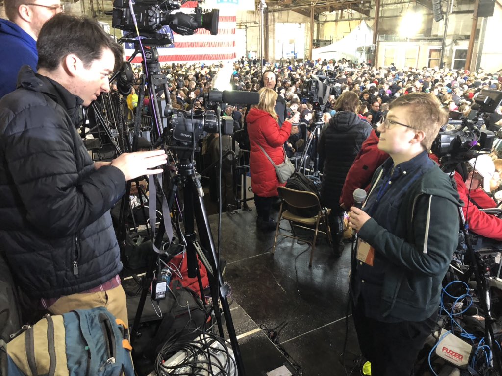 ktmcnulty's tweet photo. @PennNewsNetwork reporters, Kenny &amp; Jack recording stand-ups before @PeteButtigieg takes the stage in a soggy @DTSouthBend https://t.co/51sfdeiBZr