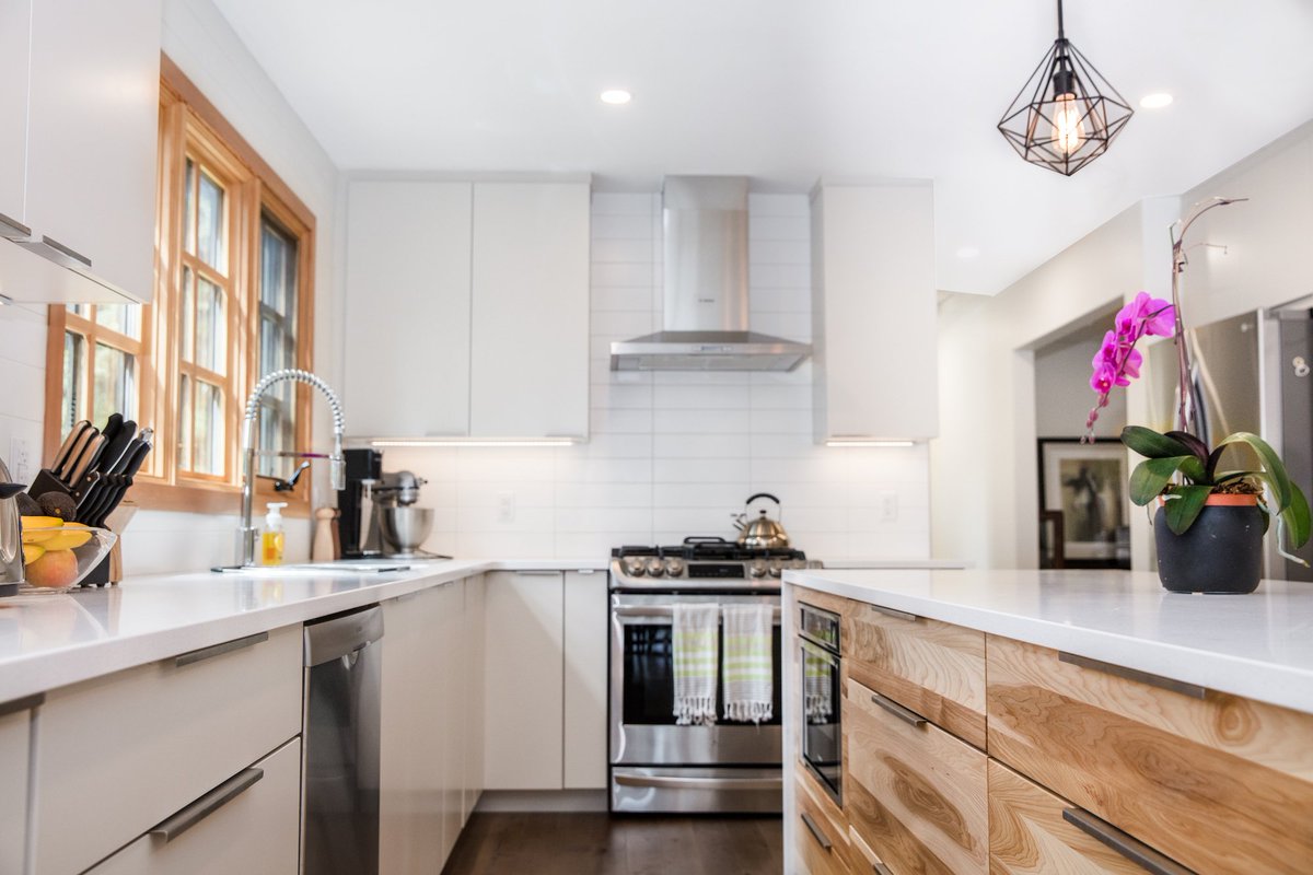 This bright kitchen uses natural light, fresh white color, and a light wood grain to create a cool contrast. Photo by <a href="/AlairEdmonton/">Alair Homes Edmonton</a>