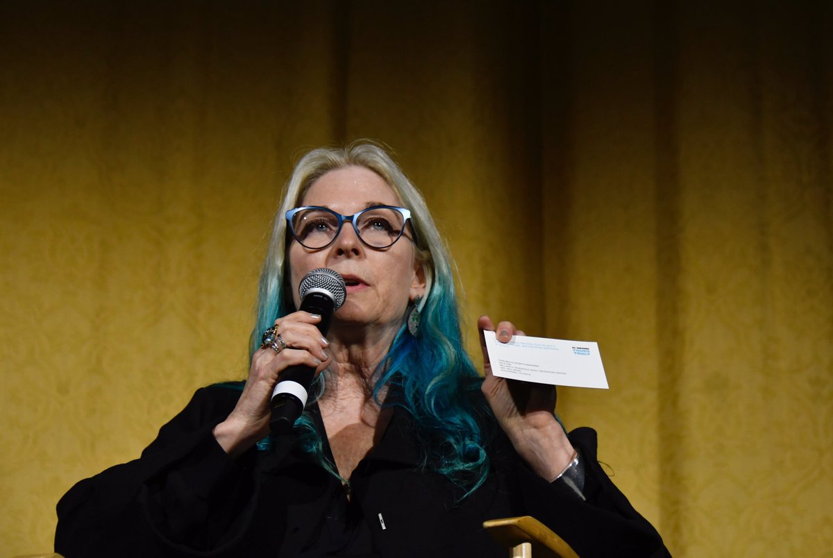 Cheryl Haines holds up a card with Chelsea Manning’s address where people can send letters.