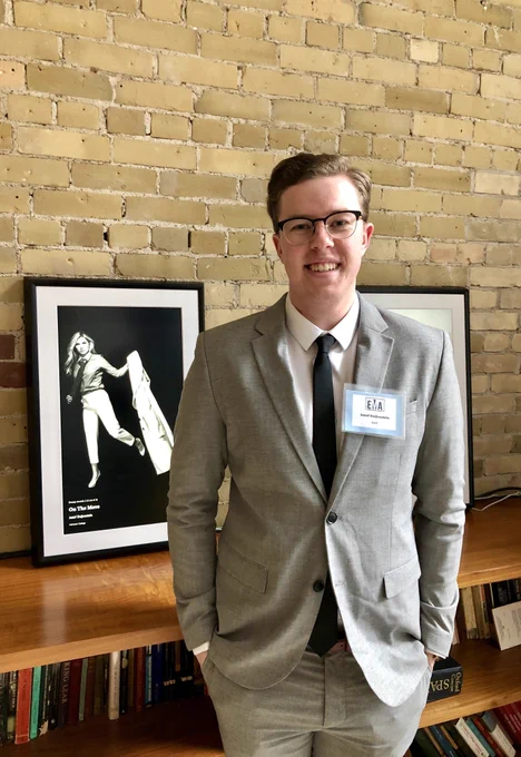 2nd year photography student Jozef standing with his artwork