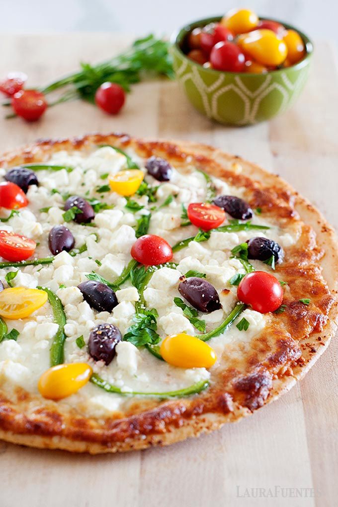 Cheesy, crispy Greek Pizza with all the Mediterran...