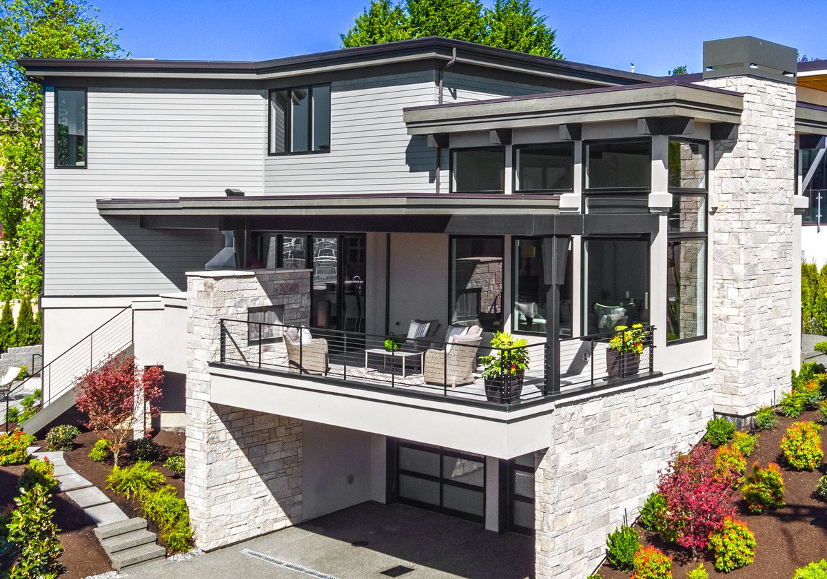 Our custom Kirkland waterfront home includes a unique balcony space featuring an outdoor stone fireplace that matches the exterior siding.

#customhomes #waterfronthomes #balconydesign #luxuryhomes #kirklandwashington #siding #stonefireplace #luxuryproperties #houseandhome