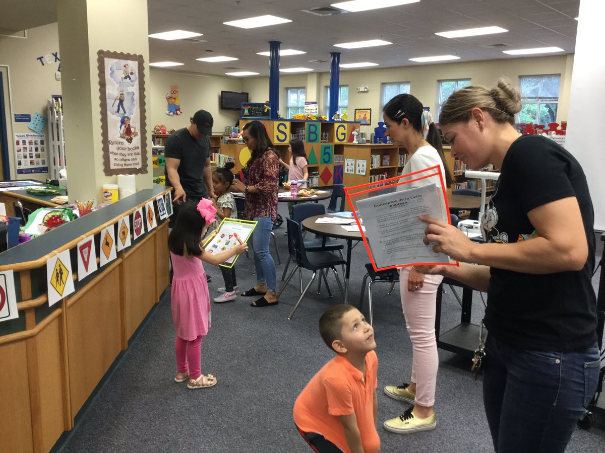 PreK Literacy Night with Teachers. Parents working with their child on Letter Scavenger Hunt using license plates. #Langleylobos