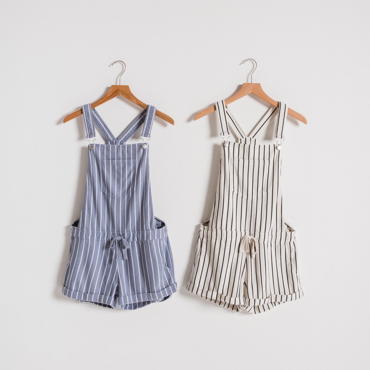 Sun-soaked summer days are calling for our Pin-Stripe Short Overalls. Which color are you loving, left or right? Shop here: hubs.ly/H0hqyhp0 #wiw