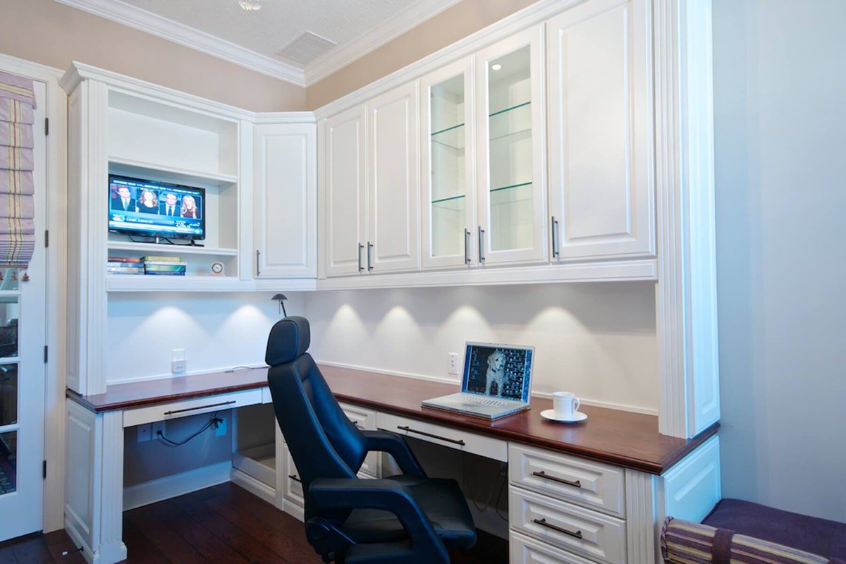 White melamine with decorative doors and end panels gives this home office a simple, clean look. #homeoffice #classicwhite #workfromhome #fortlauderdale #southflorida #designedforyou
