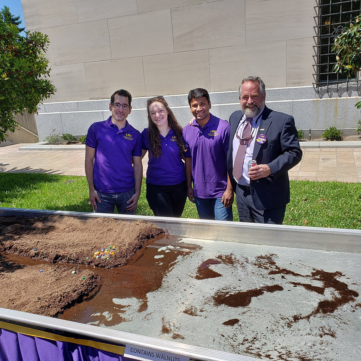 LSUResearch's tweet photo. It’s nuts at the Capitol today—Samuel J. Bentley, Interim Vice President of Research & Economic Development stops by the model delta set up by #LSU Assistant Professor Giulio Mariotti and students @LSU_CCE with sediment made from walnut shells. #containsnuts #LSUDay #lsuresearch https://t.co/3b7qITcQvr