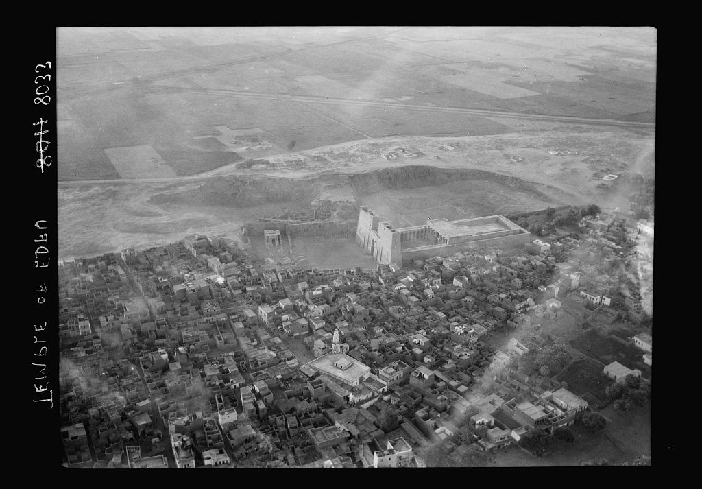What's not clear from most photos of the temple is that it is actually within (more precisely, as the edge of) the modern city of Edfu.Here's a wonderful aerial photo of the city and the temple from 1936.(Matson Photo Service via Library of Congress) http://www.loc.gov/pictures/item/mpc2010002755/PP/