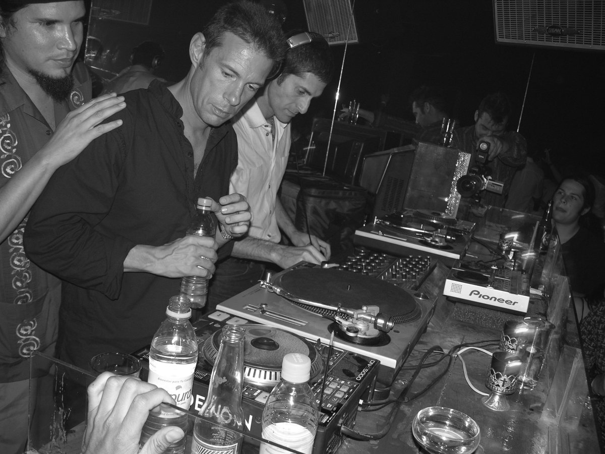 ThieveryCorpDC's tweet photo. 2004 (Playa del Carmen, Mexico) Ringing in 2005 with Rob, Eric & Perry Farrell passing the baton on the decks until the morning. The venue? Garza’s creation – the much beloved (and now shuttered) – La Santanera. #TBT #ThieveryCorporation #PerryFarrell #EricHilton #RobGarza https://t.co/oNxbaRo98h