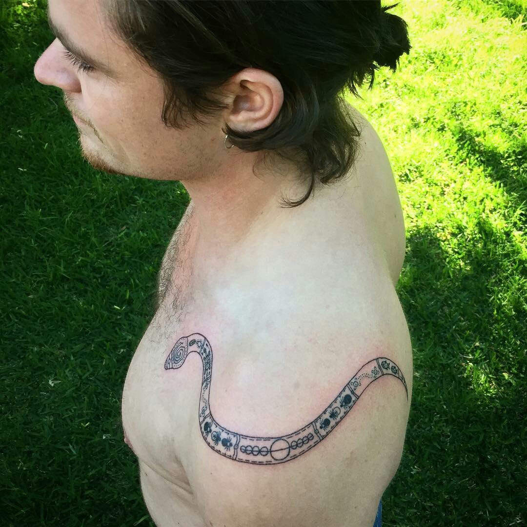 Is anyone else reminded of Cam when you see Harrison's new snake tattoo? Because we definitely are!