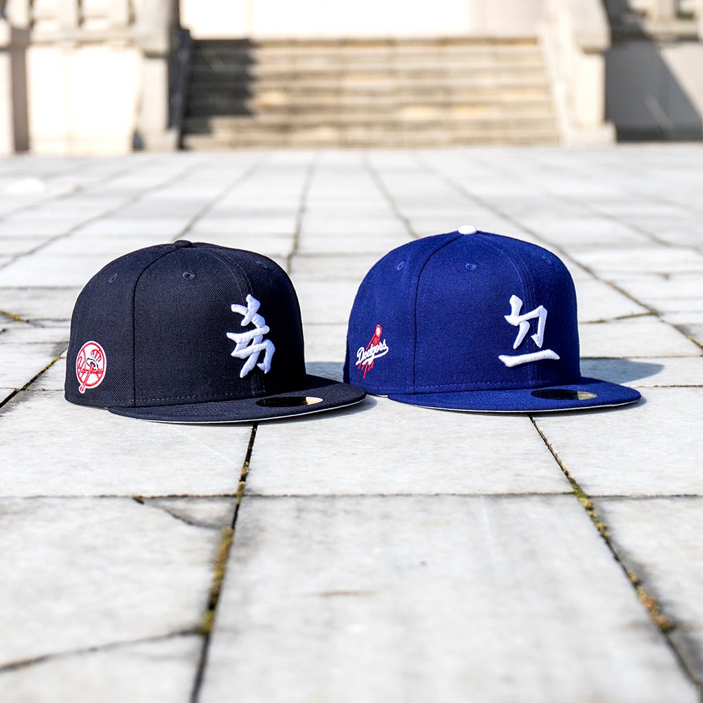 NewEraEurope's tweet photo. Two of your favourite teams, honoured in Japanese calligraphy. Shop now at https://t.co/K8OuOeFT3S. #WEREIGNASONE. https://t.co/nxbaimcQ4F
