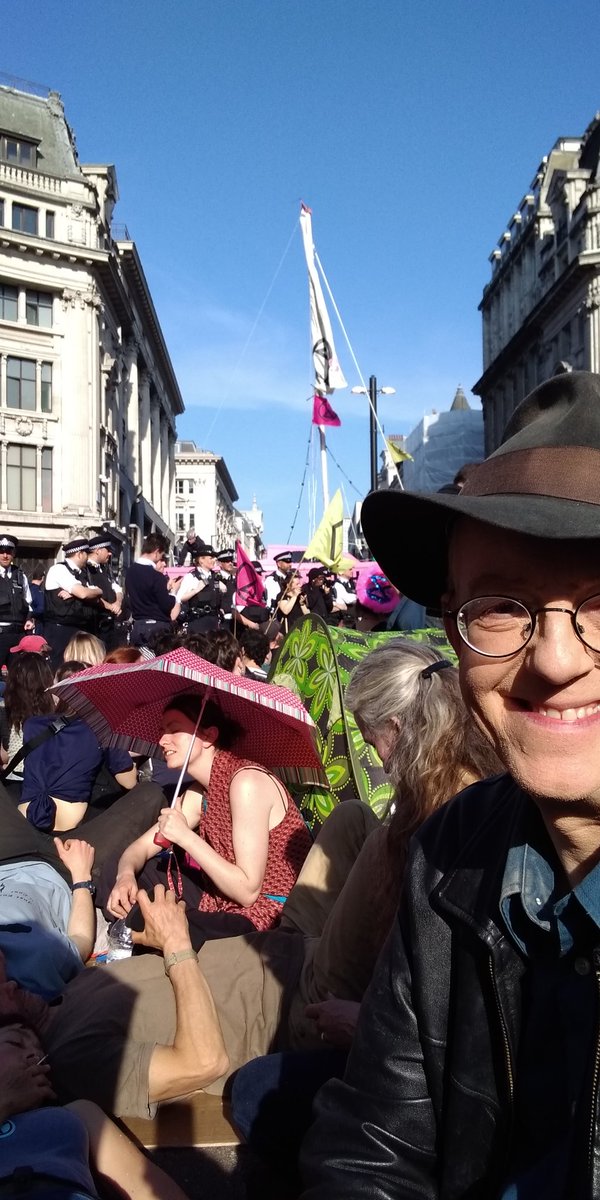 Maybe a thousand of us blocking Oxford Circus London expecting arrest surrounding a pink boat reading Tell the Truth, surrounded by police... at last a level of mass protest commensurate to the threat of #climatechange . Hoorah! #ExtinctionRebellion