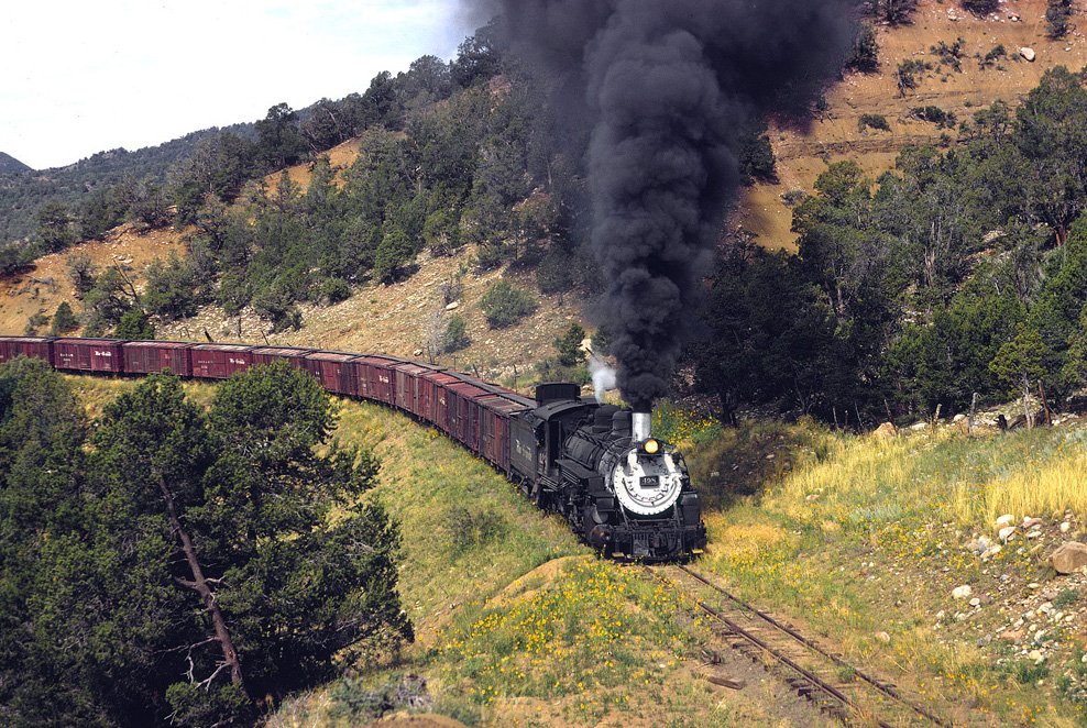 americanrails's tweet photo. Denver &amp; Rio Grande Western 2-8-2 #498 (K-37) makes the climb out of @VisitDurango with the final eastbound freight train in August, 1968.  Today, this narrow-gauge trackage is abandoned but north of Durango the line remains active under the @DSNGRR.  Drew Jacksich photo. https://t.co/ZZqd37j6OB