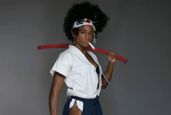Angela Hill ( @AngieOverkill) was an undefeated pro kickboxer, the Invicta straw weight champion and currently competes in the UFC where she always brandishes some awesome cosplay during her weigh ins! #MMA  #StreetFighter  #AfroSamurai