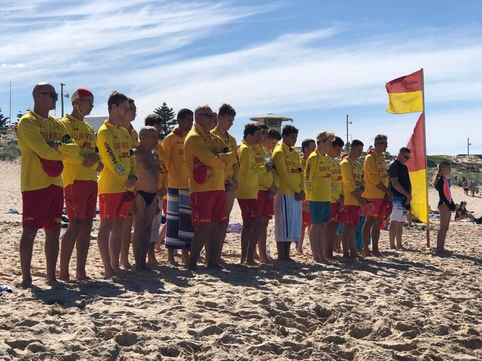 slsnsw's tweet photo. At 1230pm all NSW clubs stood in a line facing the water to honour our two fellow lifesavers who lost their lives yesterday. Andy and Ross Powell of Port Campbell SLSC will be remembered as heroes in red and yellow. condolences go out to family and friends of the Powells. #vale https://t.co/lVekhRHjKJ