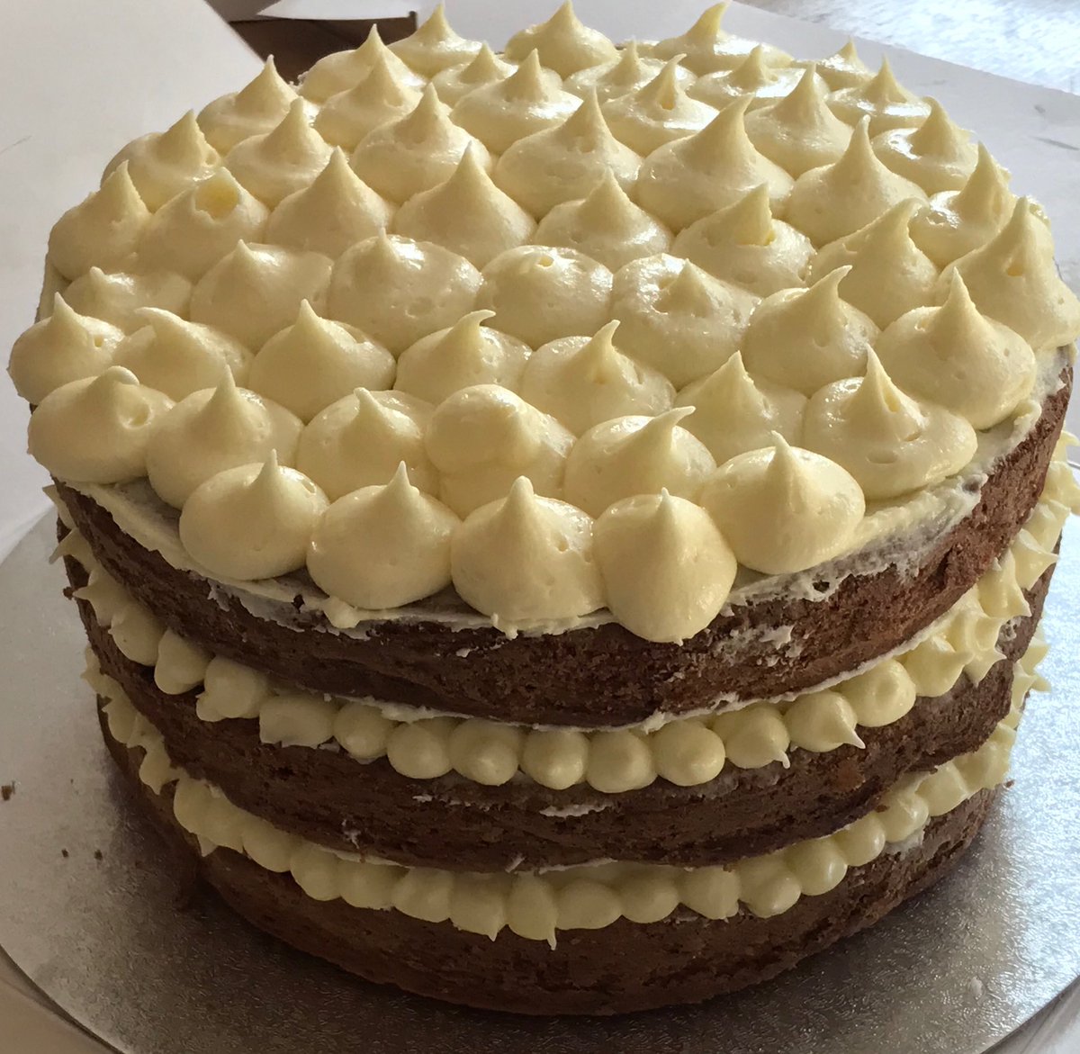 Carrot cake frosted with orange buttercream howtofeast.com